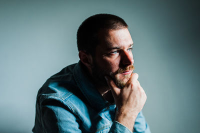 Portrait of mature man against gray background