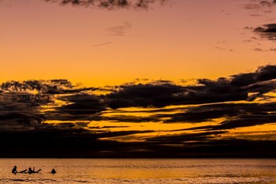 Scenic view of sea against orange sky