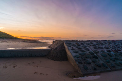 Scenic view of beach against sky during sunset