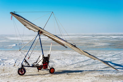 White sport hang glider on an ice field	