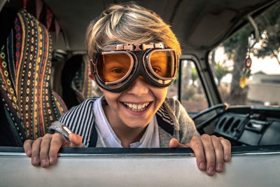 Portrait of happy boy wearing eyewear in car