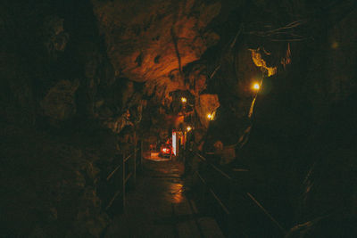 People on illuminated street at night