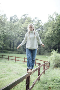 Woman balance on a fence