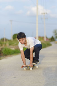 Boy riding motorcycle on road