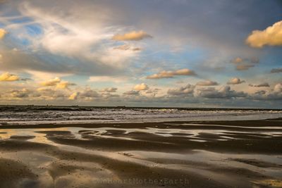 Scenic view of beach against sky during sunset