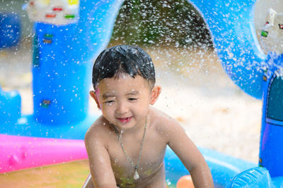 Portrait of shirtless boy in swimming pool