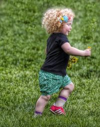 Girl standing on grassy field
