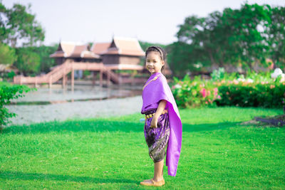 Full length of girl standing on field