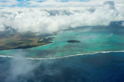 Aerial view of seascape against cloudy sky