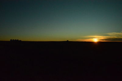 Scenic view of silhouette landscape against clear sky during sunset