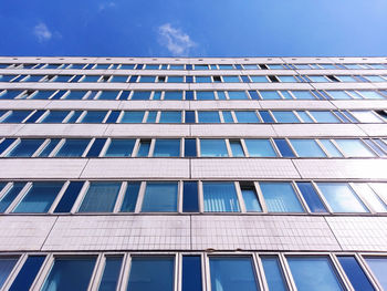 Low angle view of modern building against blue sky
