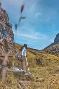 Young tourist walks on a path to the mountain. adventure travel, hiking concept.