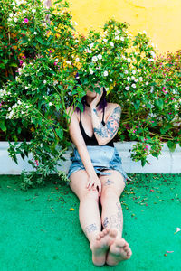 Portrait of young woman sitting on poolside