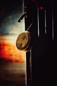 Close-up of metal hanging against sky