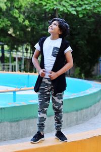 Full length of boy standing in swimming pool