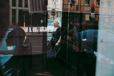 Reflection of man on glass window