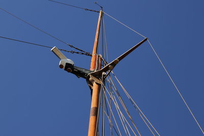 Low angle view of mast against clear blue sky