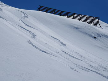 Snow covered field against sky