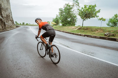 Man riding bicycle on road