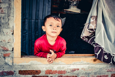 Portrait of cute boy in the window