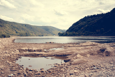 Scenic view of mountains against cloudy sky