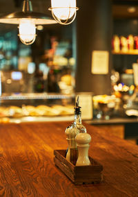 Close-up of illuminated lamp on table in restaurant