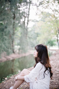 Side view of woman looking at camera