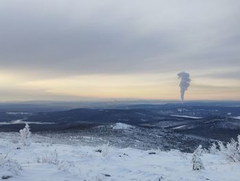 Scenic view of snow covered landscape against sky during sunset