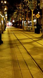 Illuminated city street at night