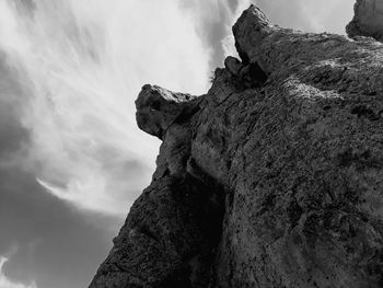 Low angle view of rock formation against sky