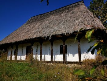 Exterior of house on field against clear sky