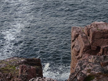 High angle view of rock by sea