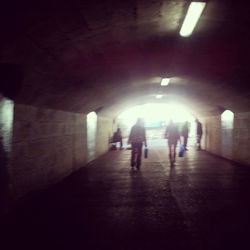 Full length of woman walking in tunnel