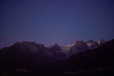 Scenic view of mountains against clear sky at night