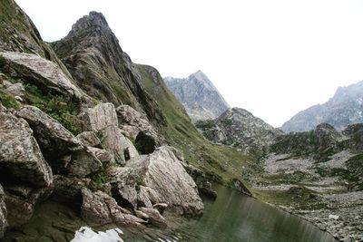 Scenic view of river amidst mountains against clear sky