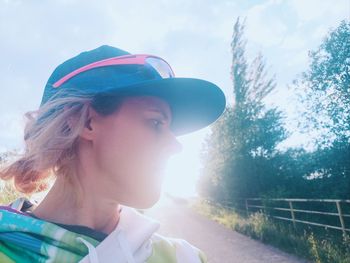 Side view of woman standing against sky