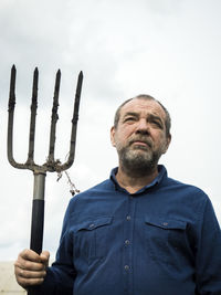 Male farmer with a pitchfork in his hands