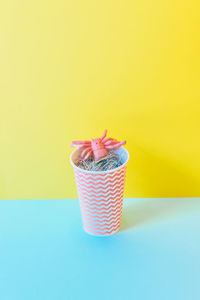 Close-up of cake on table against yellow background