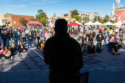 Rear view of people on street market in city