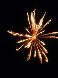 Low angle view of firework display at night