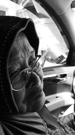 Portrait of man seen through car windshield