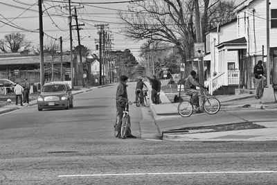 People riding bicycle on road in city