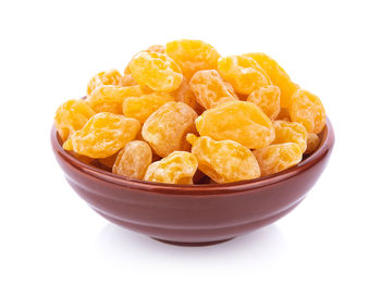 Close-up of fresh fruit in bowl against white background