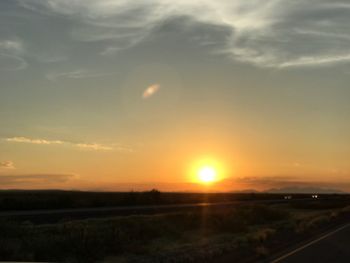 Scenic view of field against sky during sunset