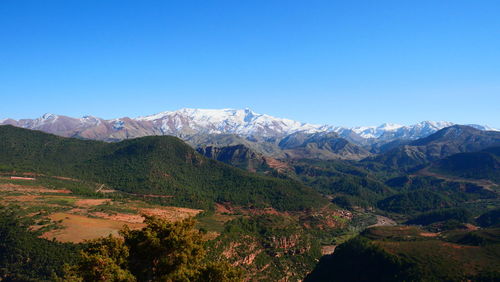 Scenic view of mountains against clear blue sky