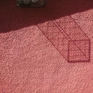 Shadow of shopping cart on wall