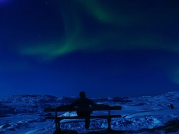 Snow covered landscape at night