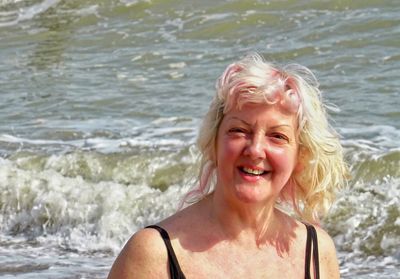 Portrait of smiling mature woman at beach