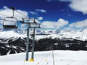 Ski lift against sky during winter