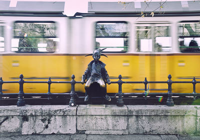 Statue against train